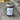 Jar of Park Winters Fig Jam on a wooden surface with a blurred outdoor background