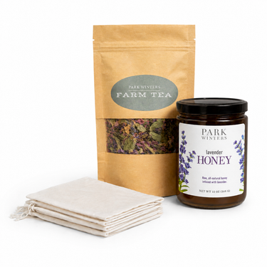 Tea package, lavender honey jar, and cloth on a white background