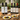 Bottles of olive oil and balsamic vinegar on a wooden table with bread and dips.