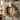 Decorative wreath with flowers and a bow on a wooden door