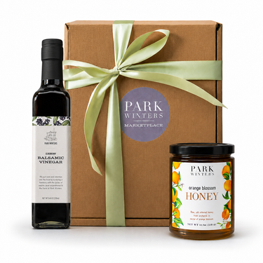 Gift set with balsamic vinegar, honey, and a box labeled 'Park Winters' on a white background.