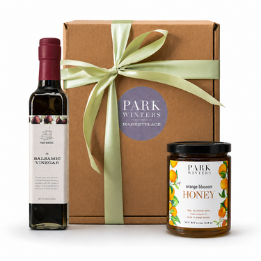 Gift set with balsamic vinegar, honey, and a box labeled 'Park Winters' on a white background.