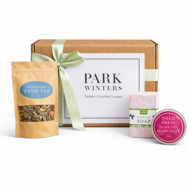 Gift set with 'Park Winters' tea package, soap, and salve on a white background